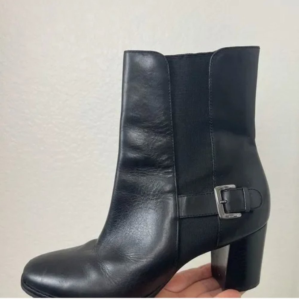 Cole Haan black leather ankle boot with silver buckle and chunky heel.